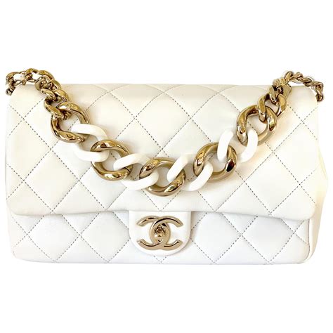 white chanel bag with gold chain.